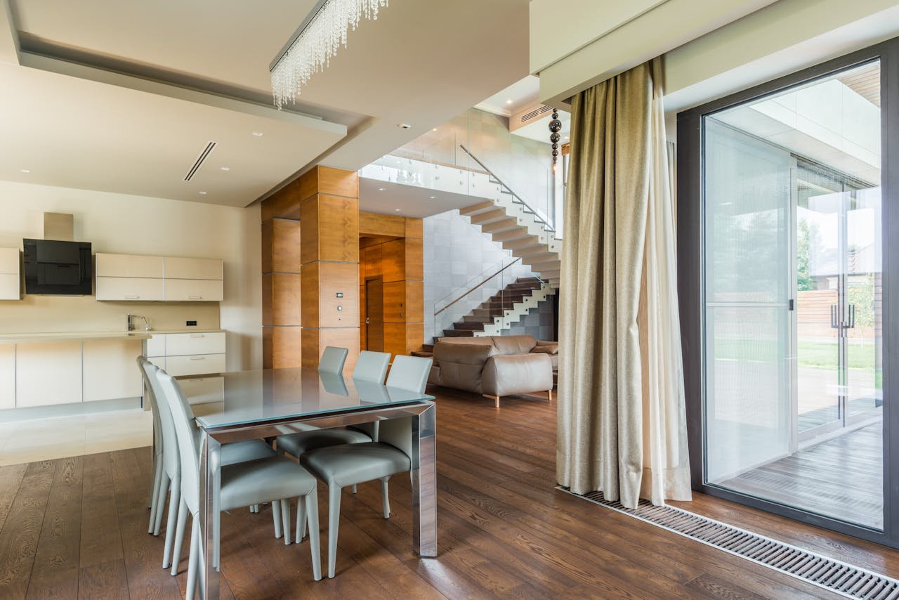 why-choose-us Spacious open-plan dining and living area featuring minimalist design and large glass wall.